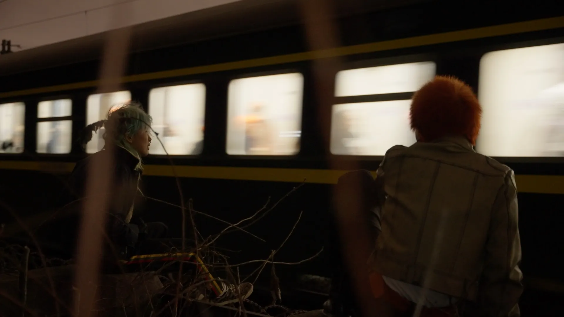 Two people from Lemphek’s documentary beside a passing train