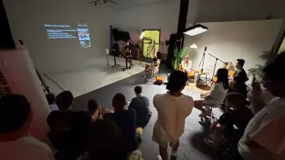 Attendees watching Lemphek’s presentation from the stepped seating at The A Frame.