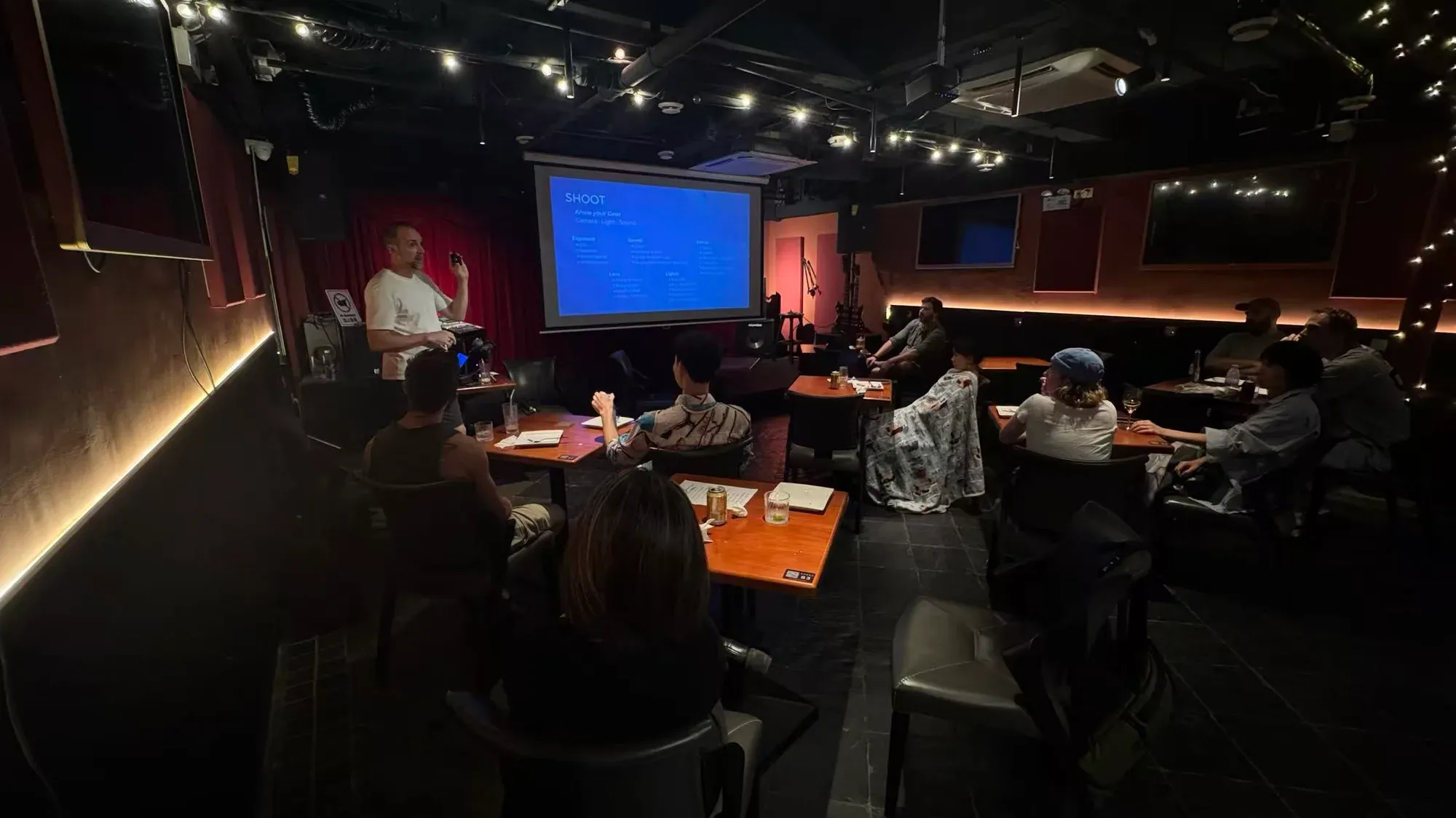 An attendee raising a hand during the Filmmaking 101 discussion with Tim Ramak