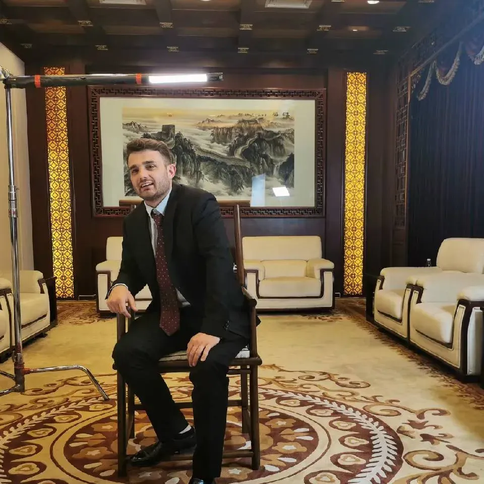 Gianluca Improta seated on a production set