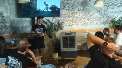 Lemphek presenting his observational documentary process to the seated audience at the Shenzhen gathering.